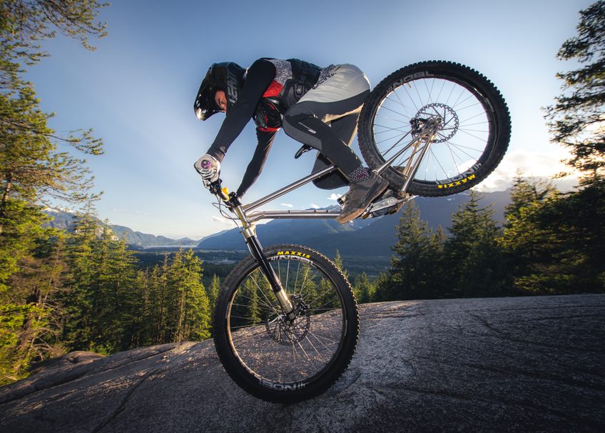 Ollie mid-manual on a granite slab above the Squamish estuary at golden hour.